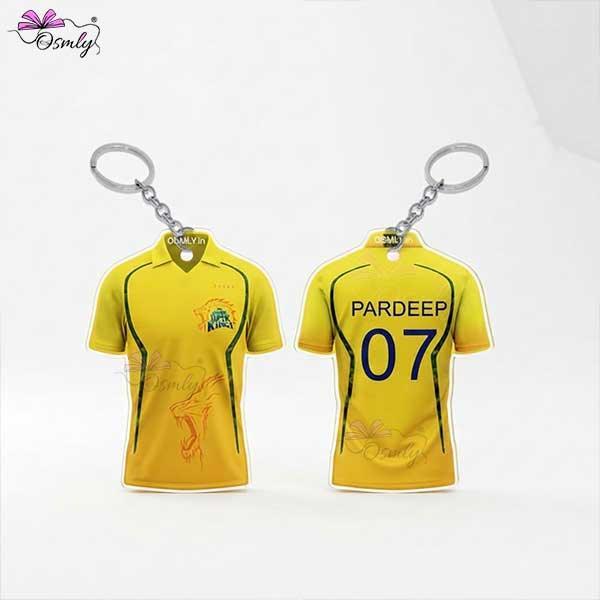 Two yellow CSK cricket jersey keychains featuring custom names and numbers.