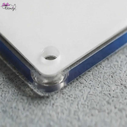 Close-up of a clear acrylic Google QR NFC keychain corner with a pre-drilled hole.