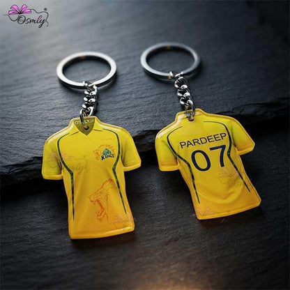 Two yellow CSK cricket jersey keychains featuring player names and numbers.